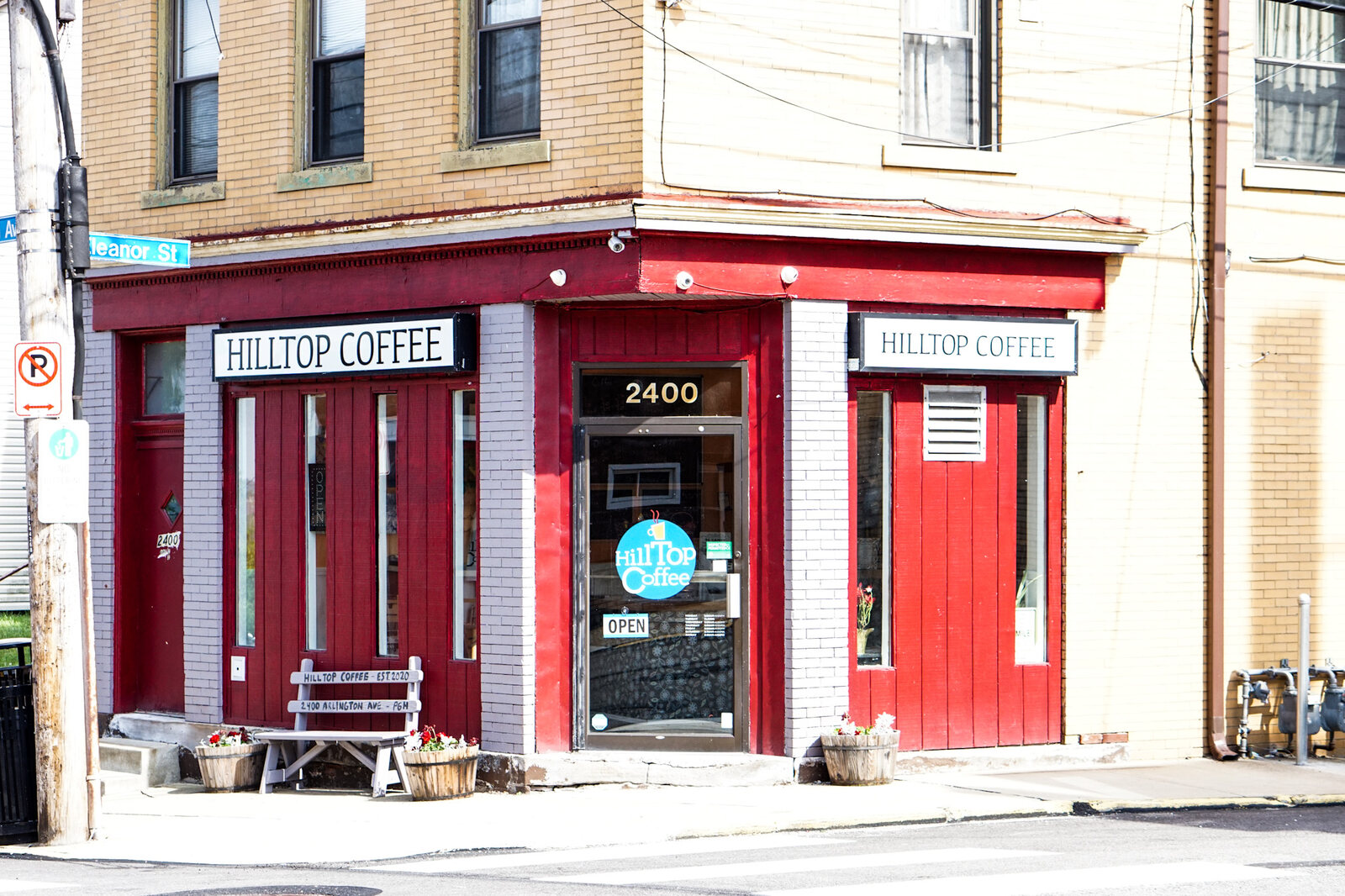 The red Hilltop Coffee storefront on the corner of Arlington Ave